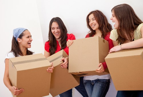 Movers using proper lifting techniques during a house move