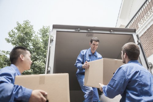 Removal company vehicle and staff following safe loading procedures
