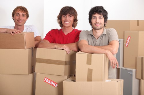 Professional pick-up team removing bulky furniture from a Balham flat