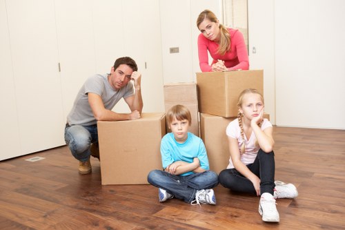 Removalists carrying furniture from a Balham home