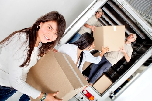 Professional movers handling furniture in a Balham property