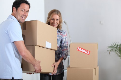 Trained removal staff handling boxes and furniture with care