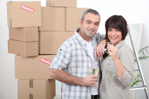 Removal professionals using safe lifting equipment during relocation